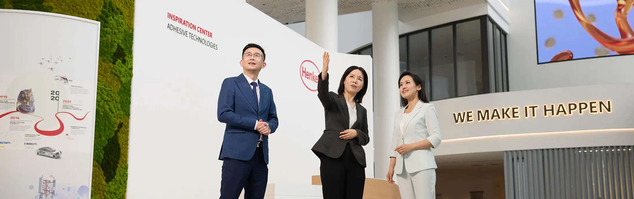 A customer experience tour guide shows two customers around the Henkel Adhesive Technologies - Inspiration Center Shanghai.