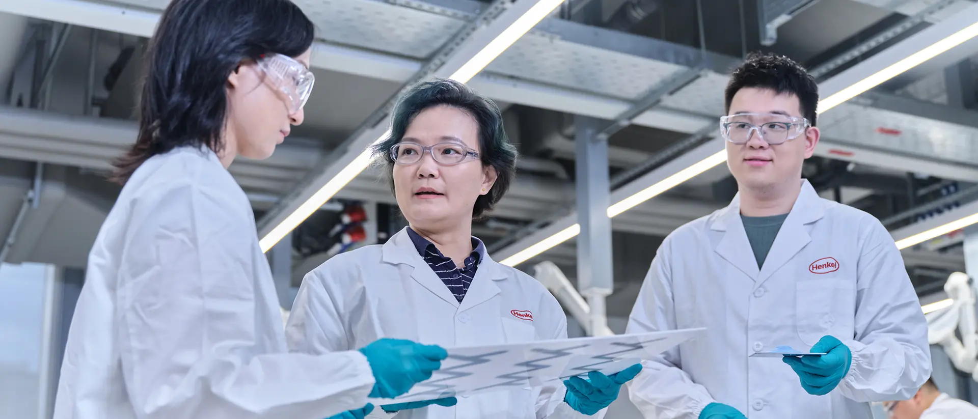 Laboratory technicians discuss thermal management tests