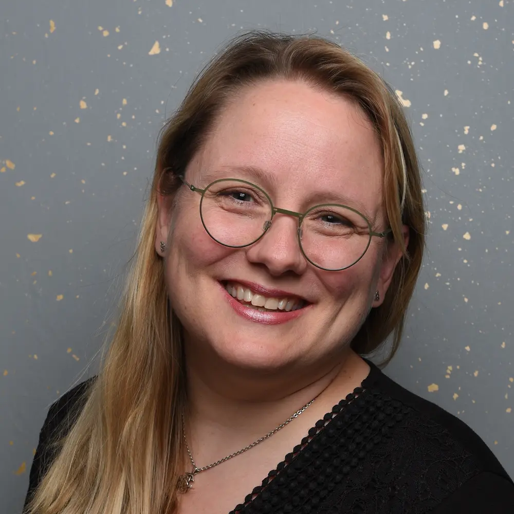 Portrait photo of Noelle, showing her smiling at the camera.